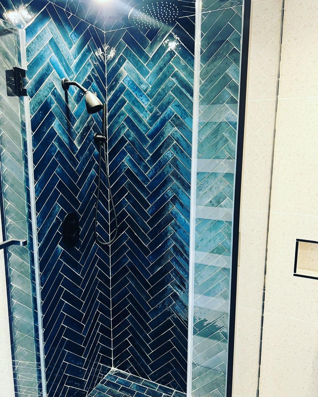 Finished herringbone-pattern blue tile shower installed by BBJ Flooring Corp
