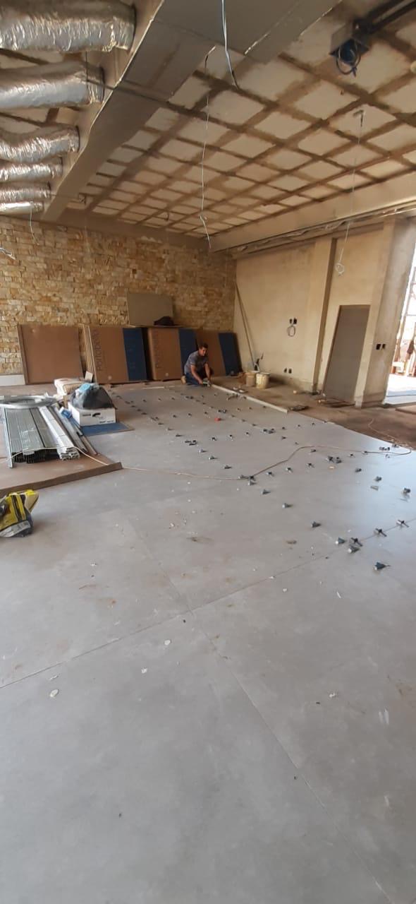 Large-format porcelain tile floor being installed by BBJ Flooring Corp