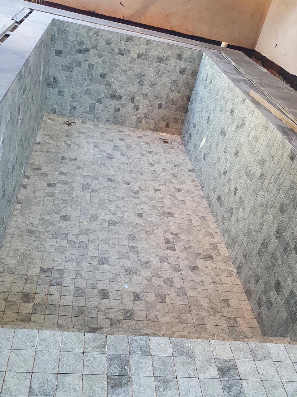 Mosaic tile pool installation mid-progress by BBJ Flooring Corp