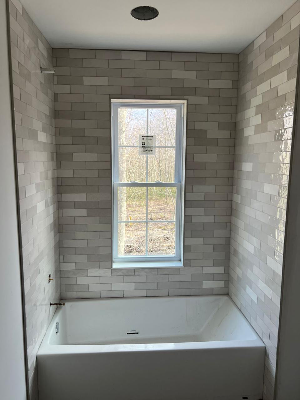 Grey subway tile tub surround installed by BBJ Flooring Corp